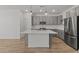 Modern kitchen features a kitchen island, grey cabinets and stainless steel appliances at 23443 W Albeniz Pl, Buckeye, AZ 85326