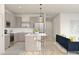 Stylish kitchen features a center island with barstool seating, stainless steel appliances, and gray cabinets at 23443 W Albeniz Pl, Buckeye, AZ 85326