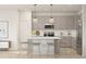 Bright kitchen with an island offering seating, stainless steel appliances, gray cabinetry and pendant lighting at 23443 W Albeniz Pl, Buckeye, AZ 85326