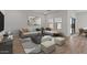 Comfortable living area with stylish sectional sofa and contemporary decor at 23443 W Albeniz Pl, Buckeye, AZ 85326