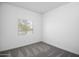 A clean, carpeted bedroom with a window offering natural light at 24571 W St Anne Ave, Buckeye, AZ 85326