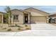 Charming single-story home featuring a two-car garage and low maintenance desert landscaping at 24571 W St Anne Ave, Buckeye, AZ 85326