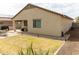 Expansive backyard with patio and table set, great for outdoor entertaining and enjoying the lawn at 25028 W Wayland Dr, Buckeye, AZ 85326