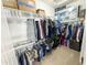 Walk-in closet with shelving, hanging racks and plenty of storage space for clothes and accessories at 25028 W Wayland Dr, Buckeye, AZ 85326
