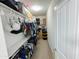 Walk-in closet with shelving, hanging racks and plenty of storage space for clothes and accessories at 25028 W Wayland Dr, Buckeye, AZ 85326