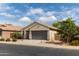 Lovely single-story home with a two-car garage and well-maintained landscaping at 25028 W Wayland Dr, Buckeye, AZ 85326