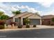 View of this tan home showing the front yard and side yard featuring desert landscaping at 25028 W Wayland Dr, Buckeye, AZ 85326