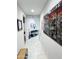 Inviting hallway featuring decorative artwork and neutral tile flooring at 25028 W Wayland Dr, Buckeye, AZ 85326