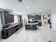 Open kitchen featuring a large island, sleek dark cabinets, and stainless appliances at 25028 W Wayland Dr, Buckeye, AZ 85326