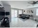 Bright living room with neutral flooring, a large sofa, and access to the outdoor area at 25028 W Wayland Dr, Buckeye, AZ 85326