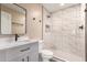 Beautiful bathroom featuring a large shower with marble tiling, matte black fixtures, and framed mirror at 2540 E Hartford Ave, Phoenix, AZ 85032