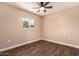 Bedroom featuring a window and dark wood flooring at 2540 E Hartford Ave, Phoenix, AZ 85032
