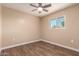 Bedroom featuring a window and dark wood flooring at 2540 E Hartford Ave, Phoenix, AZ 85032