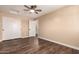 Bedroom with sliding closet doors, ceiling fan, and wood flooring at 2540 E Hartford Ave, Phoenix, AZ 85032
