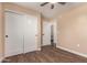 Bedroom featuring sliding closet doors, ceiling fan, and access to the bathroom at 2540 E Hartford Ave, Phoenix, AZ 85032
