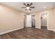 Spacious bedroom featuring wood floors, ceiling fan, and neutral color scheme at 2540 E Hartford Ave, Phoenix, AZ 85032