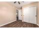 Bedroom with closet, ceiling fan, and dark wood flooring at 2540 E Hartford Ave, Phoenix, AZ 85032
