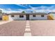 Charming home featuring a gray front door, white stucco, and rock landscaping at 2540 E Hartford Ave, Phoenix, AZ 85032