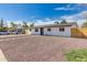 A single-story home with an low-maintenance yard and gray roof at 2540 E Hartford Ave, Phoenix, AZ 85032