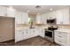 A modern kitchen featuring white cabinets, stainless steel appliances, and quartz countertops at 2540 E Hartford Ave, Phoenix, AZ 85032