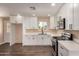Modern kitchen with quartz countertops, white cabinets, and stainless steel appliances at 2540 E Hartford Ave, Phoenix, AZ 85032