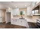 Beautiful kitchen featuring white cabinets, modern appliances, and a black faucet at 2540 E Hartford Ave, Phoenix, AZ 85032