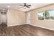 Bright living room showcasing wood-look floors, recessed lights, and a large window at 2540 E Hartford Ave, Phoenix, AZ 85032