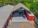 Aerial view of barn with covered work areas and red shipping container at 25829 S Mandarin Dr, Queen Creek, AZ 85142