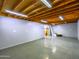 Spacious basement featuring concrete floors, exposed ceiling joists, and fluorescent lighting at 25829 S Mandarin Dr, Queen Creek, AZ 85142