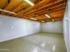 Spacious basement featuring concrete floors, exposed ceiling joists, and fluorescent lighting at 25829 S Mandarin Dr, Queen Creek, AZ 85142
