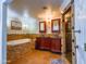 Bathroom featuring a large soaking tub, double sink vanity, stone accents, and walk-in shower with glass door at 25829 S Mandarin Dr, Queen Creek, AZ 85142