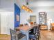 Dining room with a rustic wood table, stylish chairs, and modern pendant lighting at 25829 S Mandarin Dr, Queen Creek, AZ 85142