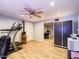 A large exercise room, with a treadmill, rowing machine, ceiling fan, and an office area at 25829 S Mandarin Dr, Queen Creek, AZ 85142