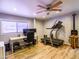 Large exercise room with a ceiling fan, desk and a treadmill by a bright window at 25829 S Mandarin Dr, Queen Creek, AZ 85142