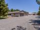Exterior view of home featuring an attached garage, long driveway, and red outbuilding at 25829 S Mandarin Dr, Queen Creek, AZ 85142