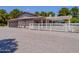 Ranch-style home with a large garage, covered patio, and white fence at 25829 S Mandarin Dr, Queen Creek, AZ 85142