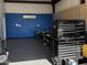 Spacious garage with blue accent wall, storage cabinets and workbench area at 25829 S Mandarin Dr, Queen Creek, AZ 85142