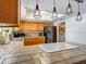 Bright kitchen featuring tile countertops, modern appliances, and a breakfast bar at 25829 S Mandarin Dr, Queen Creek, AZ 85142
