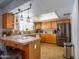 Well-lit kitchen with wood cabinets, tile countertops, and stainless steel appliances at 25829 S Mandarin Dr, Queen Creek, AZ 85142