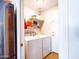 Bright laundry room featuring a washer, dryer, storage shelves and a stainless steel Samsung refrigerator at 25829 S Mandarin Dr, Queen Creek, AZ 85142