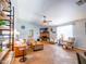 Inviting living room with a brick fireplace, tile flooring, and stylish furnishings at 25829 S Mandarin Dr, Queen Creek, AZ 85142