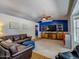 Spacious living room featuring modern blue accent wall, plush seating, and lots of light at 25829 S Mandarin Dr, Queen Creek, AZ 85142