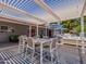 Outdoor dining area featuring a shaded pergola, comfortable seating, and stylish decor, perfect for entertaining and relaxation at 25829 S Mandarin Dr, Queen Creek, AZ 85142