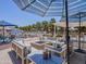 Outdoor living space with fire pit, comfortable seating, and umbrellas, creating a cozy atmosphere for relaxation and gatherings at 25829 S Mandarin Dr, Queen Creek, AZ 85142