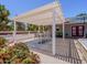 Outdoor pergola area with a dining set and manicured landscaping, ideal for al fresco dining and entertaining at 25829 S Mandarin Dr, Queen Creek, AZ 85142