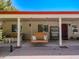 Inviting covered patio with swing, wicker furniture, and a view to the home's entrance at 25829 S Mandarin Dr, Queen Creek, AZ 85142