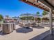 Inviting patio area with comfortable outdoor seating and umbrellas for shade and relaxation at 25829 S Mandarin Dr, Queen Creek, AZ 85142