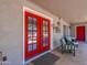 Charming porch with red french doors and outdoor seating, perfect for relaxing and enjoying the surroundings at 25829 S Mandarin Dr, Queen Creek, AZ 85142