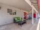 Cozy outdoor porch area with a green cushioned seating area, creating a comfortable space at 25829 S Mandarin Dr, Queen Creek, AZ 85142