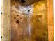 Walk-in shower with stone accents, multiple shower heads, and decorative bronze fixtures at 25829 S Mandarin Dr, Queen Creek, AZ 85142